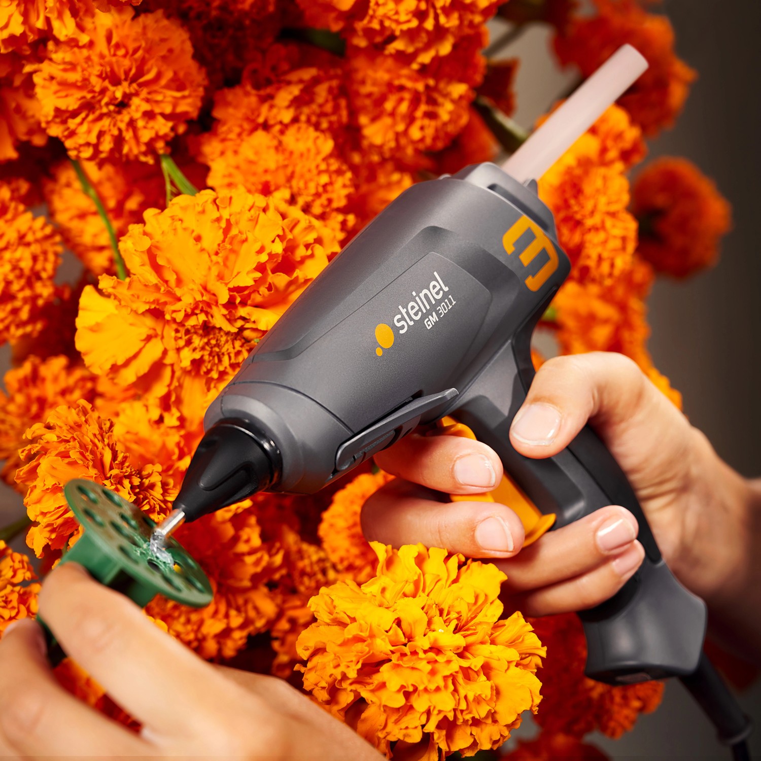 Steinel Heißklebepistole Gluematic 3011 beim Basteln mit Blumen, Detailaufnahme.