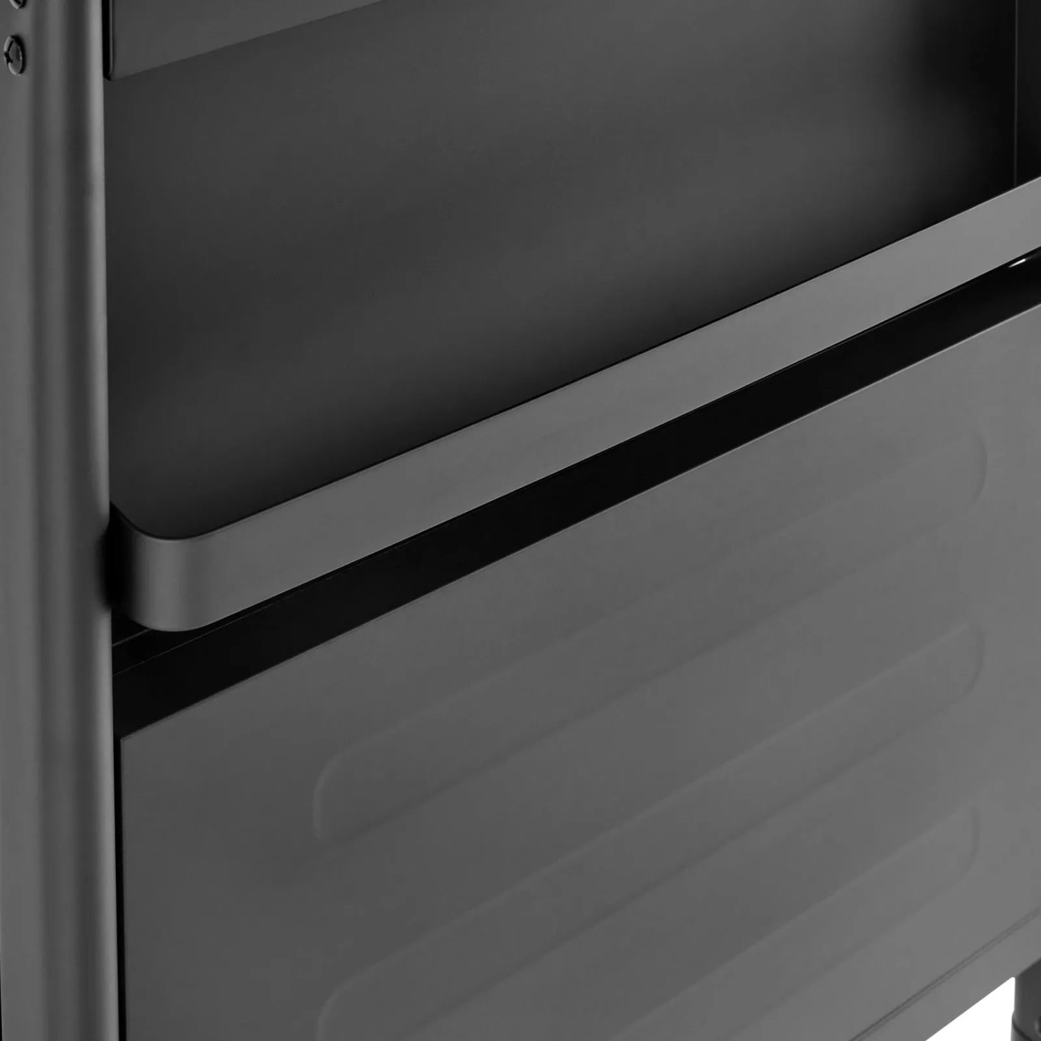 Schwarze, einklappbare Seitenablage des Taino Compact 3+0 Gasgrills mit geriffelter Metallstruktur.