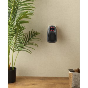 Schwarze BALDERIA SH500 Steckdosenheizung an Wand, neben Pflanze. Kompakte, portable Elektroheizung.