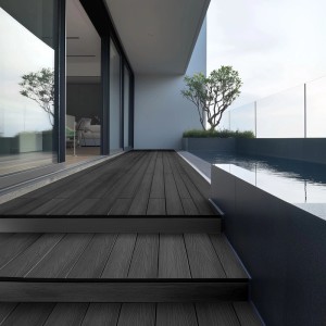 Anthrazitfarbene WPC-Terrassendielen Samana Premium von Home Deluxe auf einer Terrasse mit Pool.
