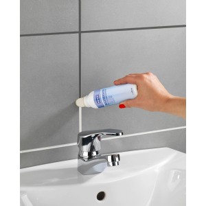 Anwendung von Wenko Fugenweiß 125ml zur Erneuerung von Fliesenfugen im Bad.