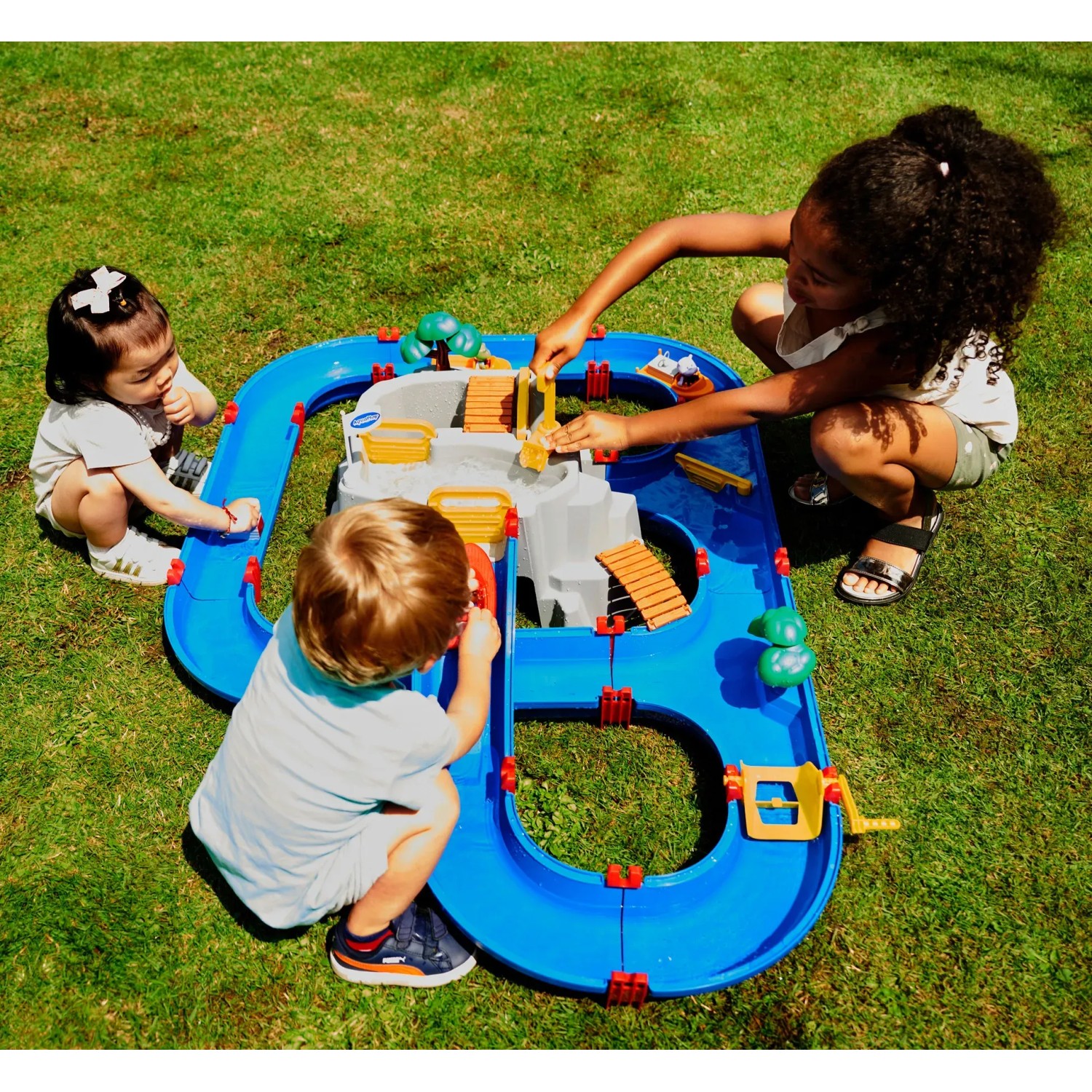 Kinder spielen mit AquaPlay MountainLake Wasserbahn. Buntes Set mit Berg, Booten und Figuren.