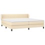 Cremefarbenes Boxspringbett 200x200 cm mit Matratze und Kopfteil.