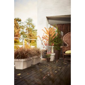 Hoher, weißer Elho Blumentopf Loft Urban (Ø 42 cm) mit Bepflanzung auf einer Terrasse.